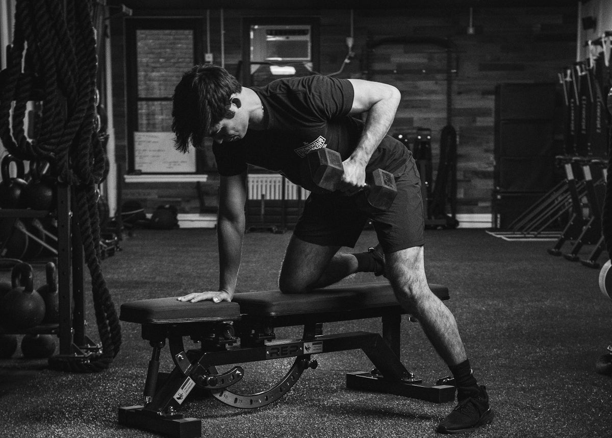 a man doing a bench press in a gym