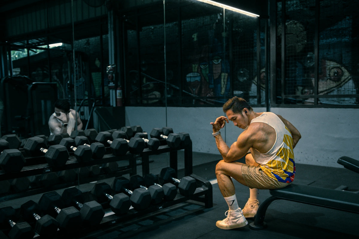 A man sitting on a bench in a gym